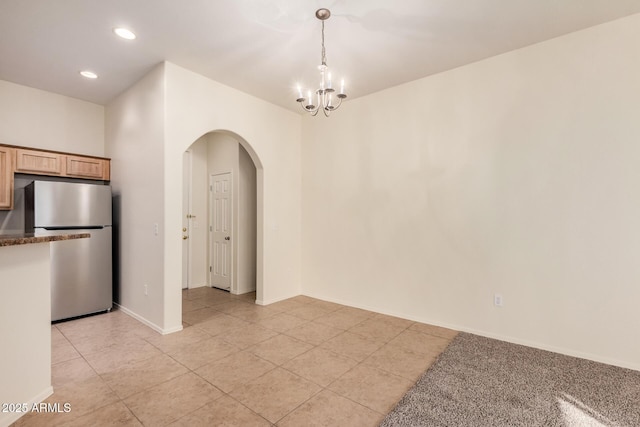 interior space featuring a notable chandelier and light tile patterned flooring