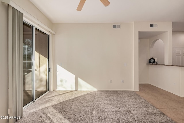 unfurnished room featuring ceiling fan and tile patterned floors