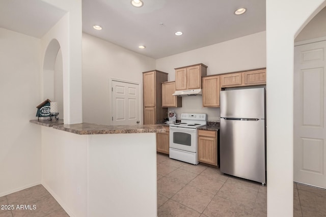 kitchen featuring white electric range oven, light brown cabinetry, light tile patterned floors, stainless steel fridge, and kitchen peninsula