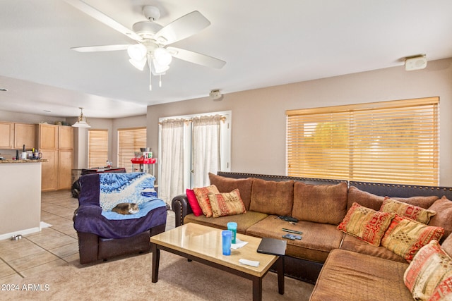 living room featuring ceiling fan, light tile patterned floors, and plenty of natural light