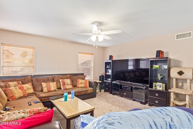 carpeted living room with ceiling fan