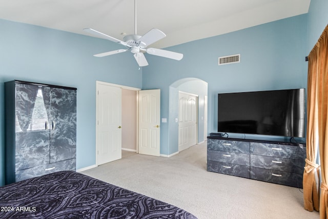 carpeted bedroom with high vaulted ceiling and ceiling fan