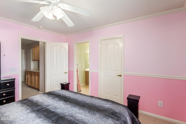 carpeted bedroom featuring ceiling fan, ensuite bathroom, and ornamental molding