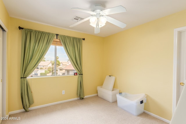 unfurnished room featuring light colored carpet and ceiling fan