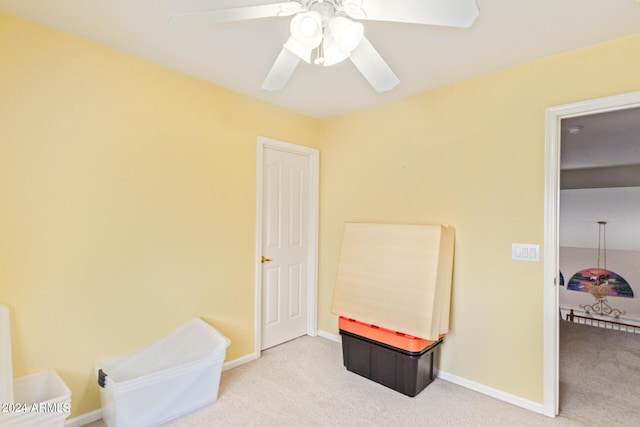 recreation room featuring light carpet and ceiling fan