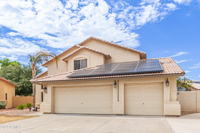 view of front of house featuring a garage and solar panels