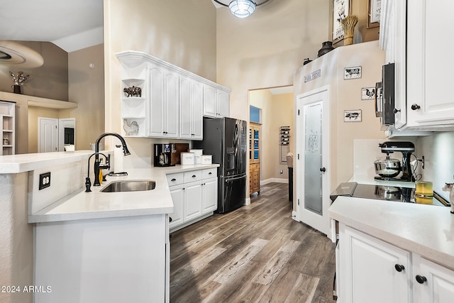 kitchen featuring white cabinetry, sink, stainless steel refrigerator with ice dispenser, and hardwood / wood-style flooring