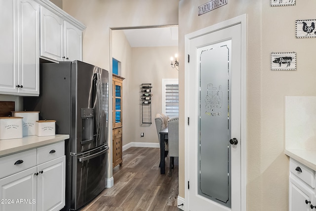 kitchen featuring white cabinets, stainless steel fridge, and dark hardwood / wood-style flooring