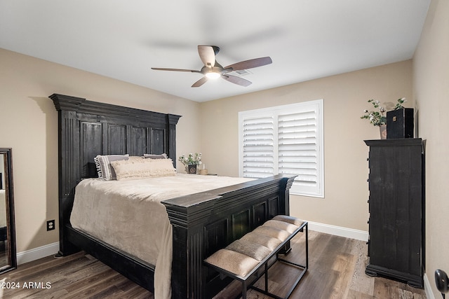 bedroom with dark hardwood / wood-style flooring and ceiling fan