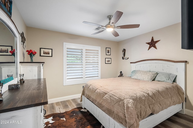 bedroom with ceiling fan and dark wood-type flooring