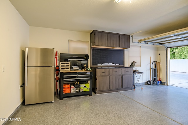 garage with stainless steel refrigerator