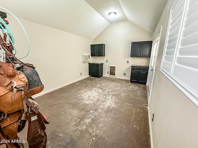 unfurnished living room with vaulted ceiling