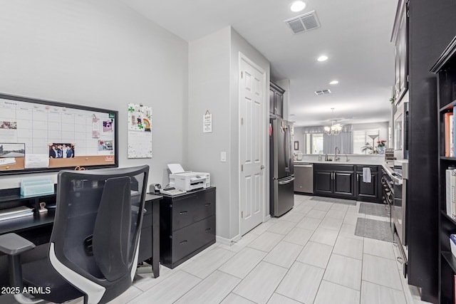 office space featuring an inviting chandelier, recessed lighting, visible vents, and a sink
