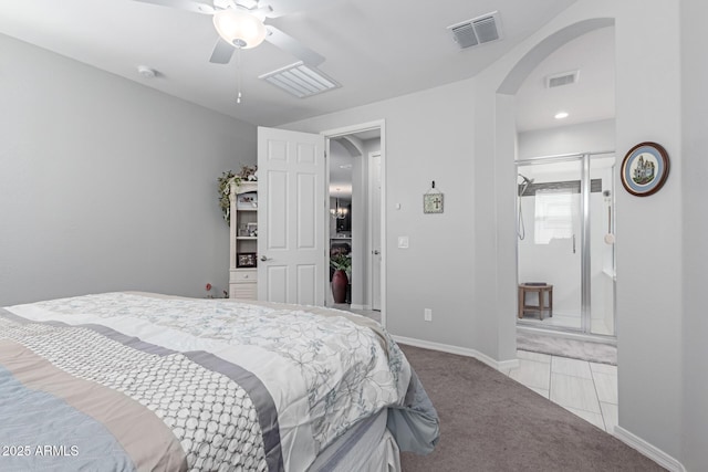 carpeted bedroom featuring visible vents, arched walkways, baseboards, and a ceiling fan