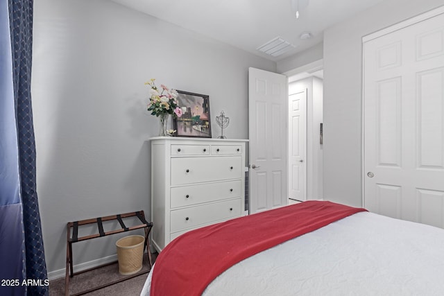 carpeted bedroom with visible vents and baseboards