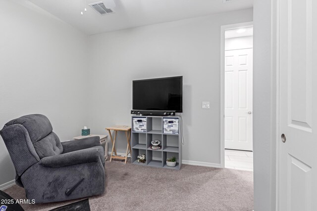 living area featuring visible vents, baseboards, and carpet floors