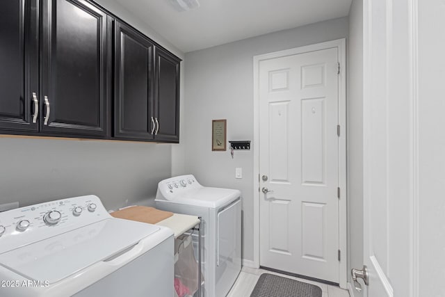 clothes washing area featuring visible vents, cabinet space, and independent washer and dryer