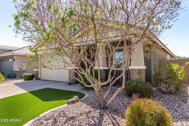 obstructed view of property with stucco siding, driveway, and fence