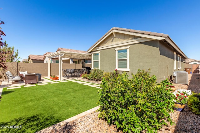 rear view of house with a patio, an outdoor living space, a pergola, and stucco siding