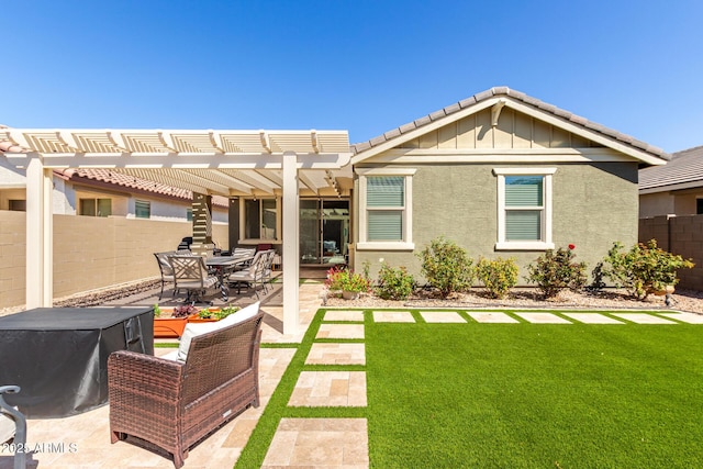 rear view of property featuring outdoor dining space, fence, a pergola, a patio area, and a lawn
