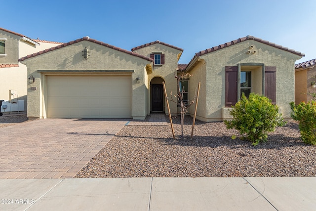 mediterranean / spanish-style home featuring a garage