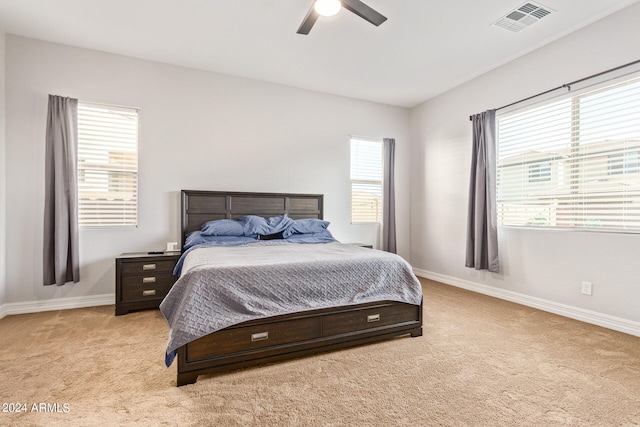 bedroom with light colored carpet and ceiling fan