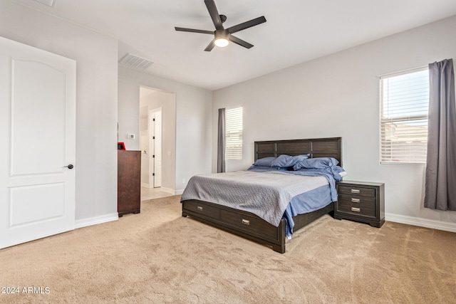 bedroom featuring light colored carpet and ceiling fan