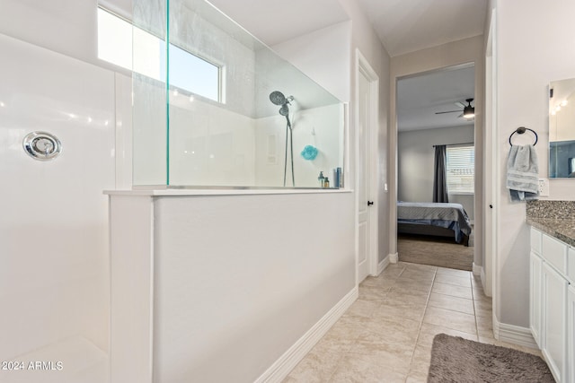 bathroom with a shower, vanity, ceiling fan, and tile patterned floors