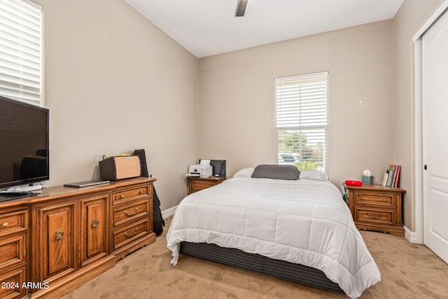 bedroom featuring light carpet, a closet, and ceiling fan