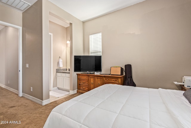 carpeted bedroom with ensuite bath