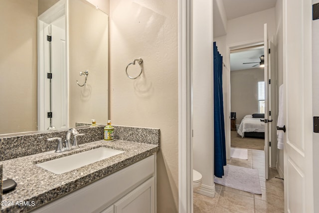 bathroom featuring vanity, tile patterned floors, ceiling fan, and toilet