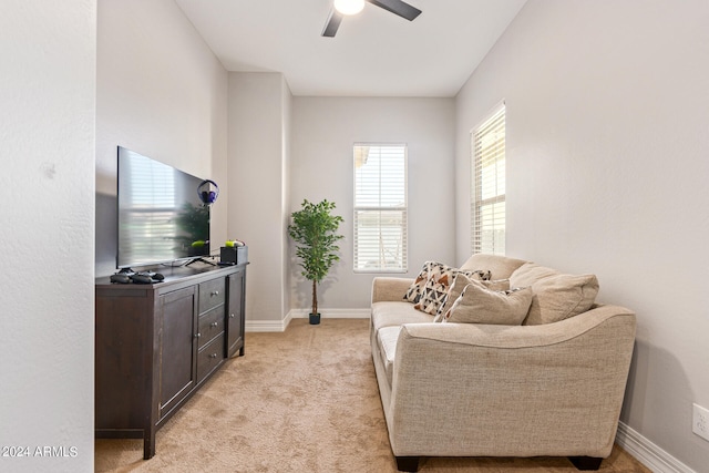 carpeted living room with ceiling fan