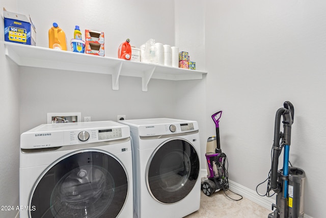 clothes washing area with washing machine and dryer