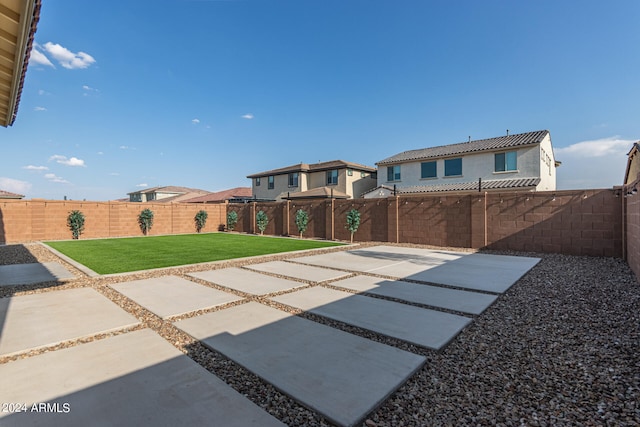 exterior space with a patio area and a lawn