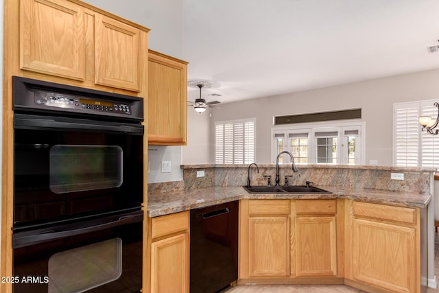 kitchen with sink, light stone counters, black appliances, kitchen peninsula, and light brown cabinets