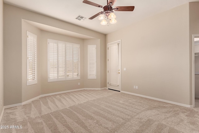 unfurnished room with light carpet and ceiling fan