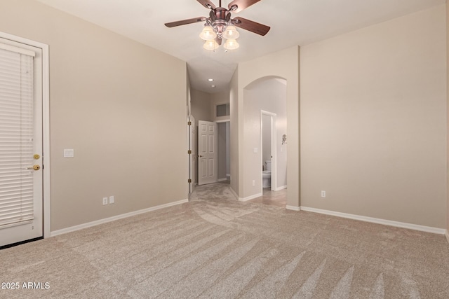 carpeted spare room featuring ceiling fan