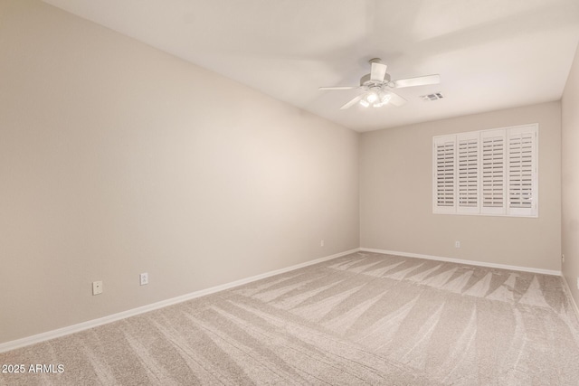 spare room with ceiling fan and carpet