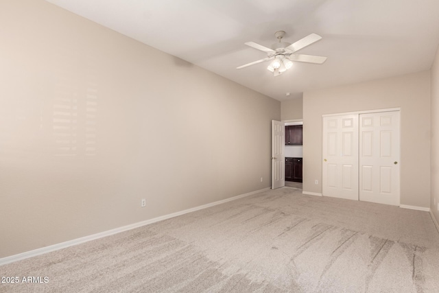 unfurnished bedroom with ceiling fan, carpet, and a closet