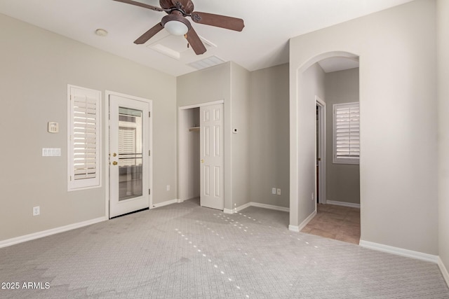 unfurnished bedroom featuring light carpet and ceiling fan