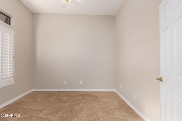 tiled spare room with ceiling fan