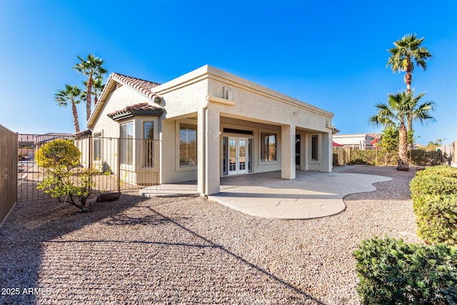 back of house featuring a patio area and french doors