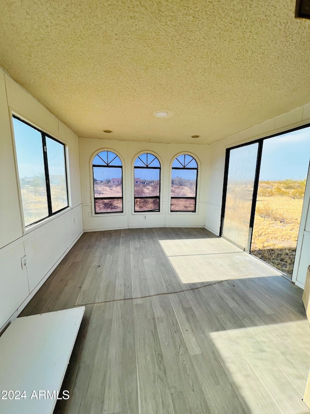 unfurnished sunroom with a healthy amount of sunlight