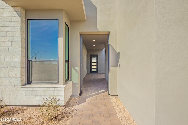 entrance to property with stucco siding