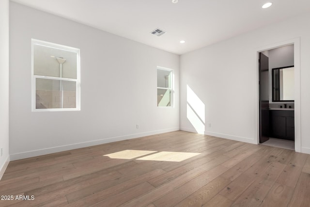 empty room with visible vents, recessed lighting, baseboards, and light wood-style floors