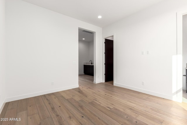 empty room with recessed lighting, visible vents, baseboards, and hardwood / wood-style flooring