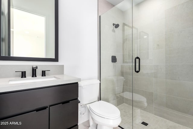 full bathroom with a shower stall, toilet, and vanity