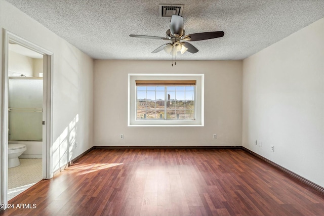 empty room featuring ceiling fan and dark wood-type flooring