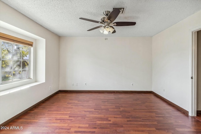 unfurnished room with a textured ceiling, dark hardwood / wood-style floors, and ceiling fan