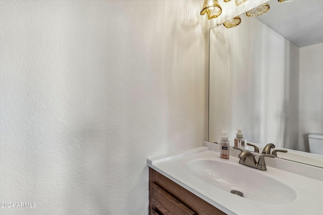 bathroom with toilet and vanity